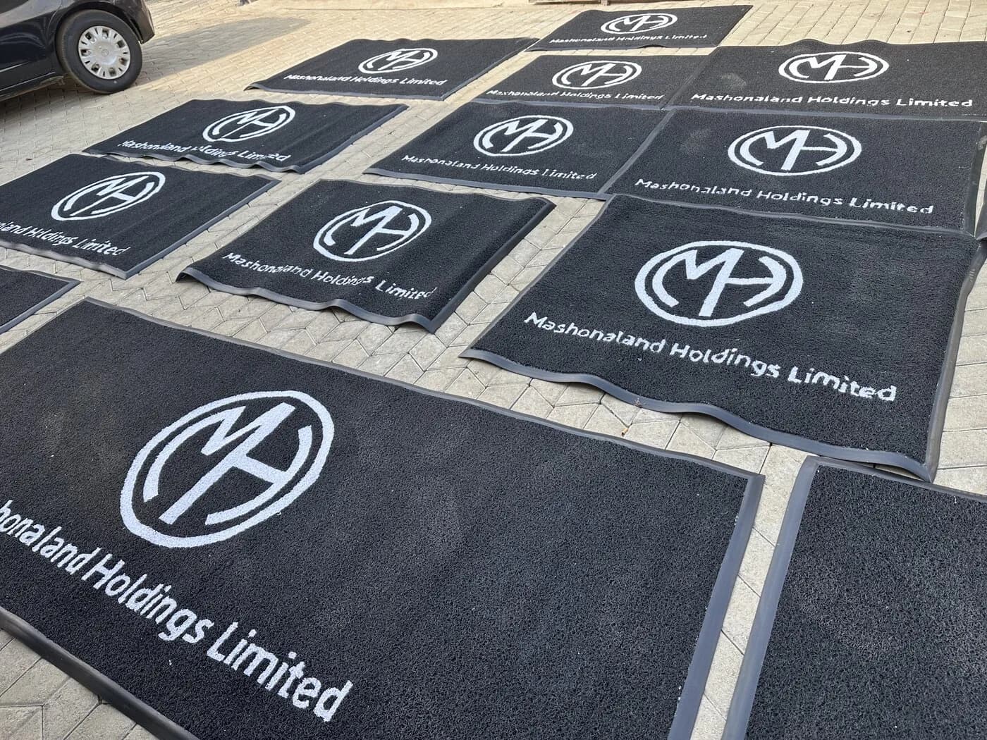 Branded entrance mat installed at a retail store entrance